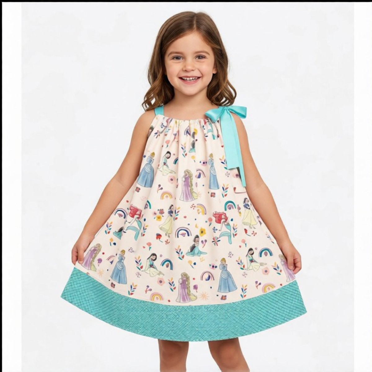Young girl wearing a colorful dress with princesses and rainbows on a white background