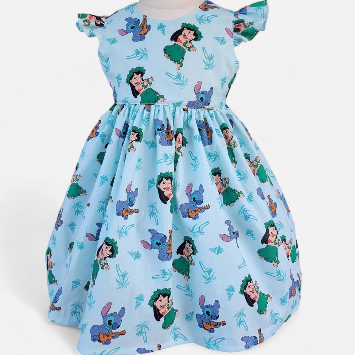 Children's dress with cartoon character print on a light blue background