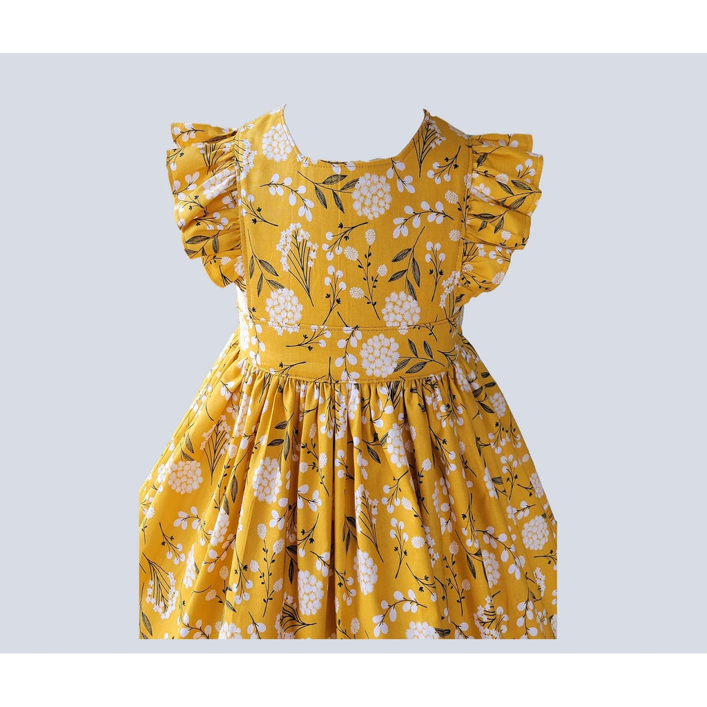 Yellow dress with floral pattern on a light gray background