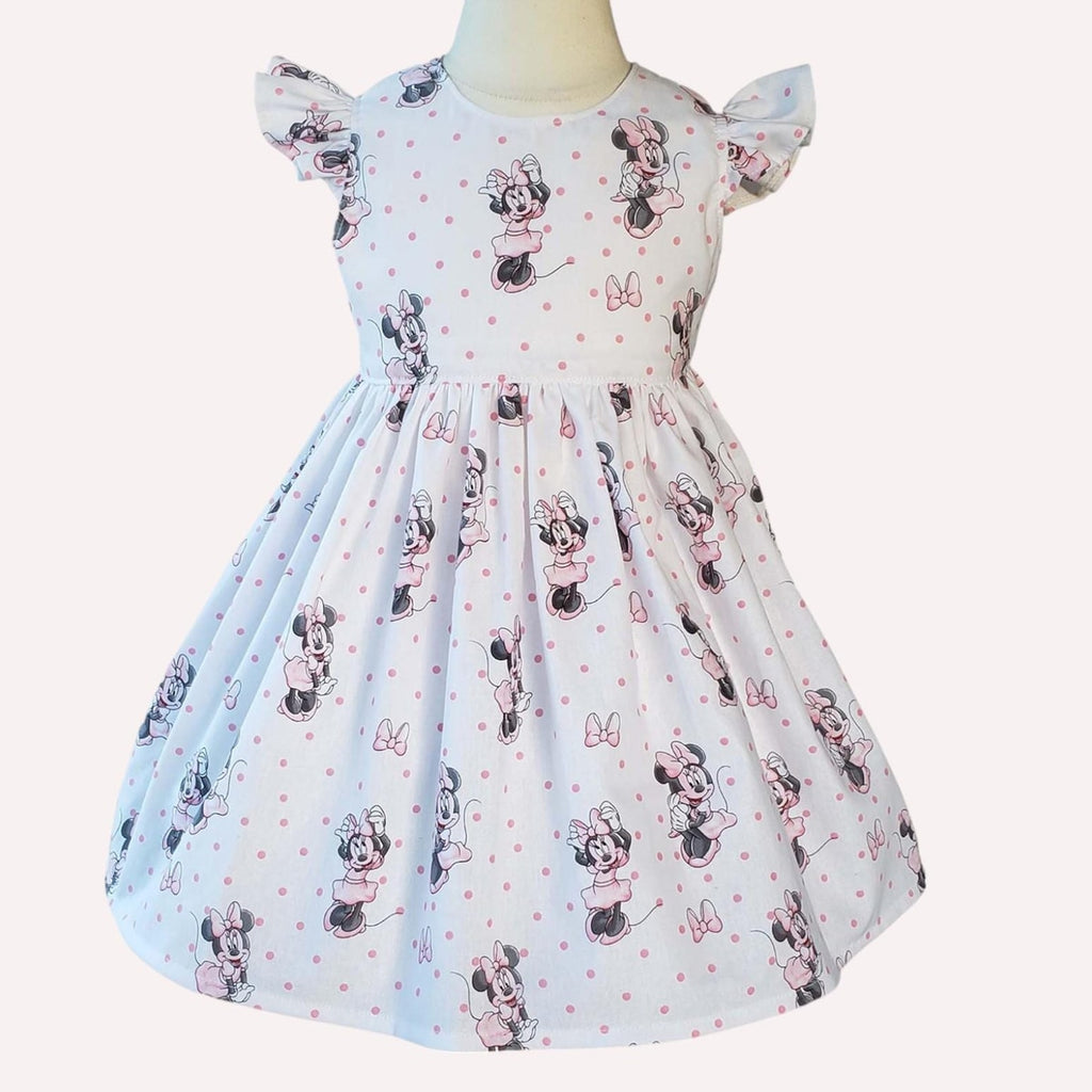 Children's dress with Minnie Mouse pattern on a white background