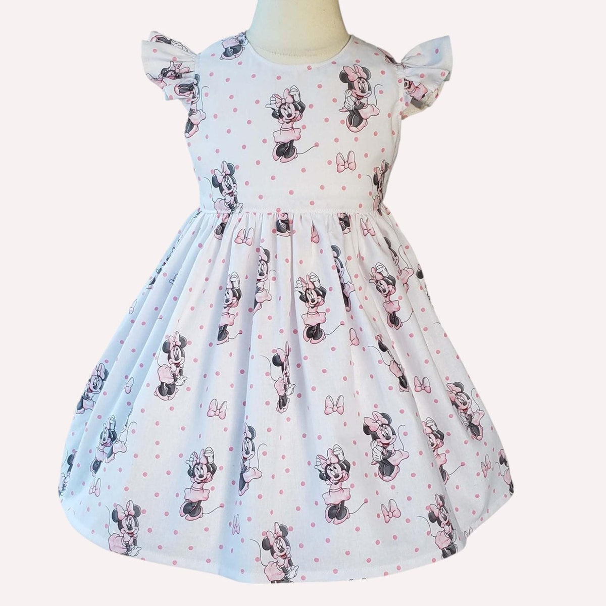Children's dress with Minnie Mouse pattern on a white background