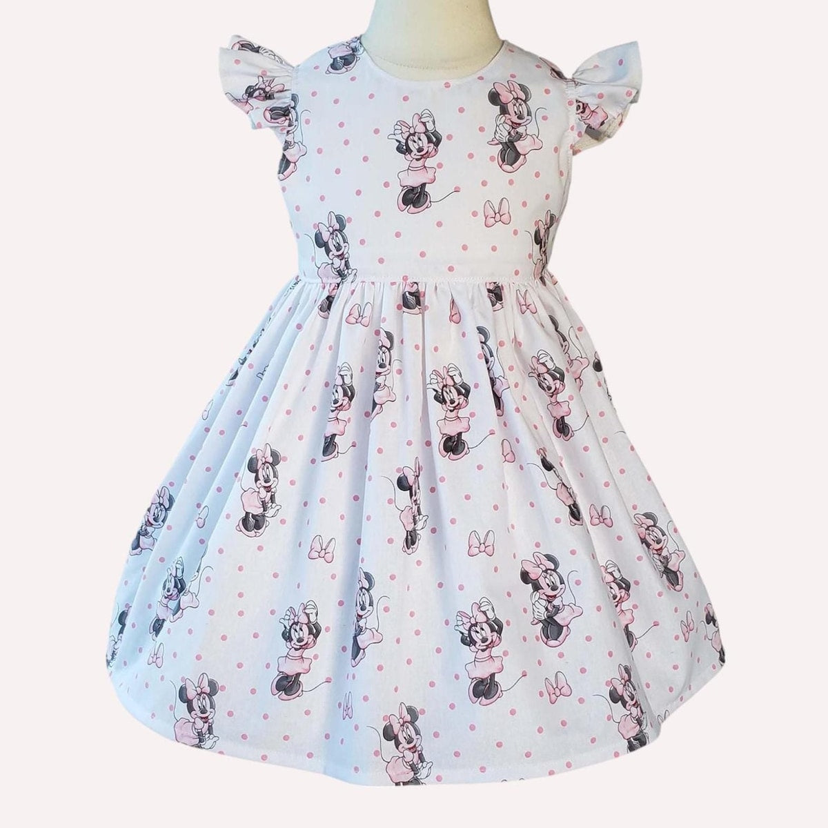 Children's dress with Minnie Mouse pattern on a white background