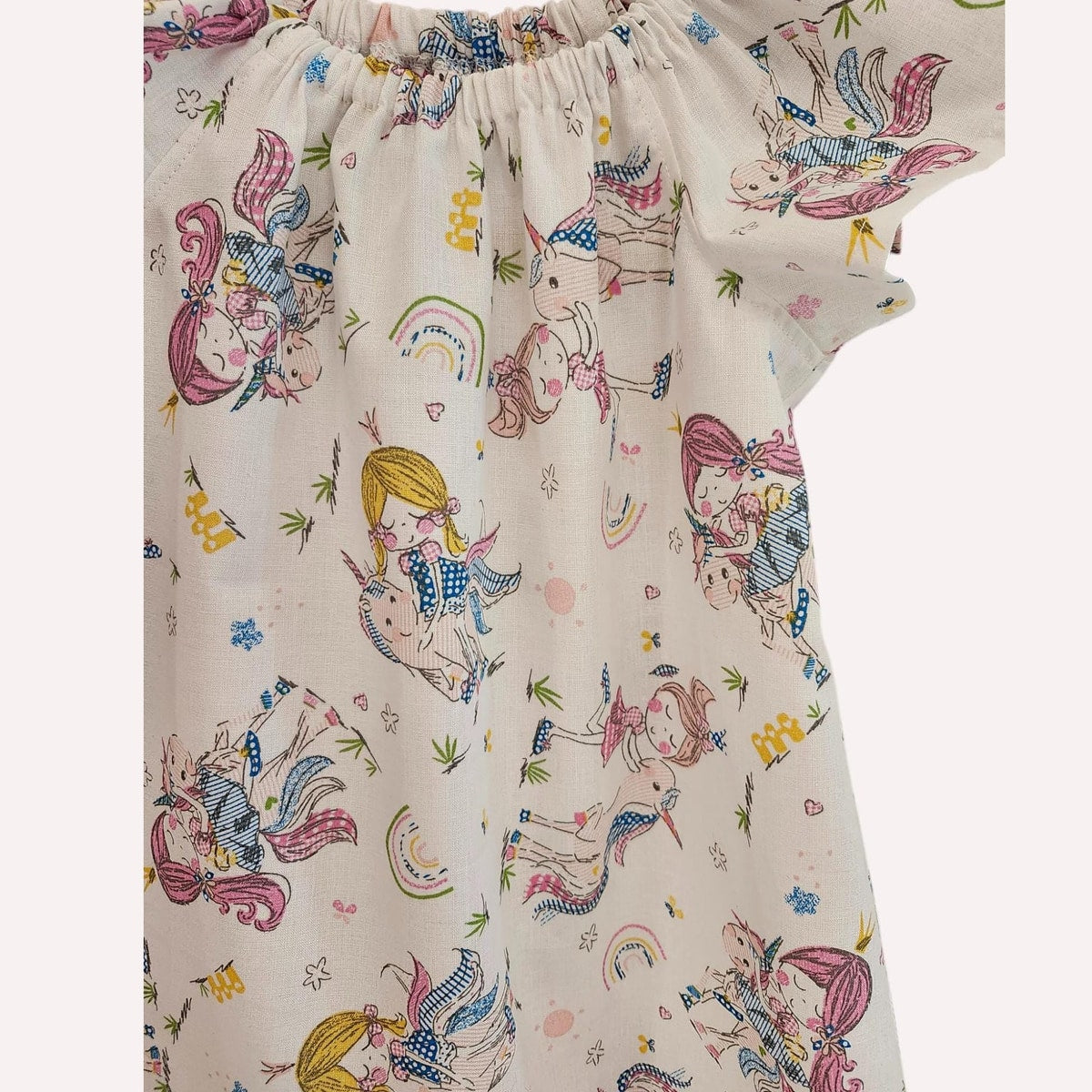 Children's dress with colorful unicorn and fairy pattern on a white background