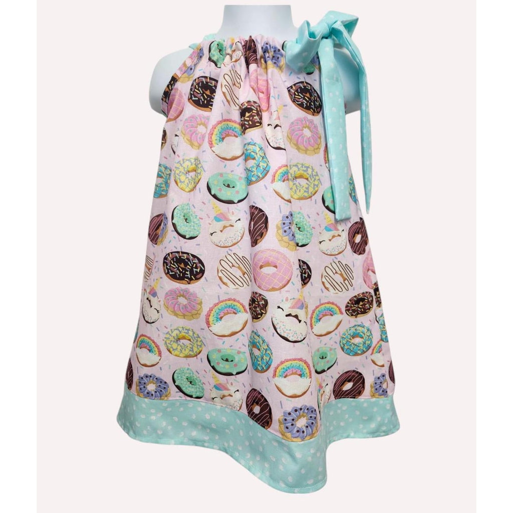 Colorful apron with donut pattern on a mannequin against a white background