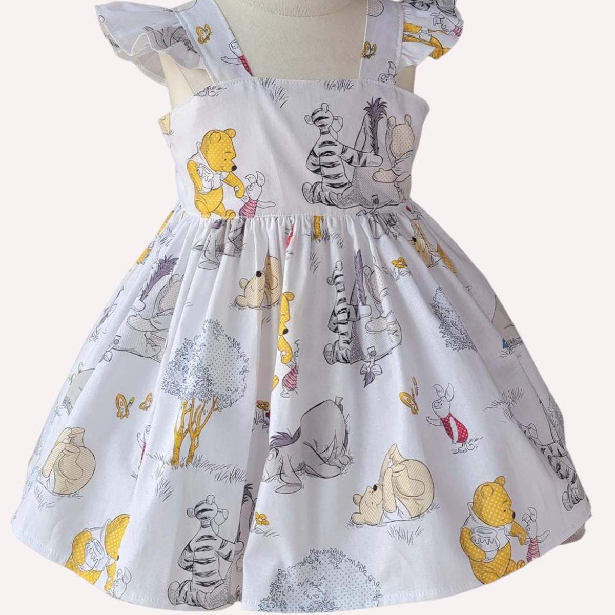 Children's dress with cartoon character print on a white background