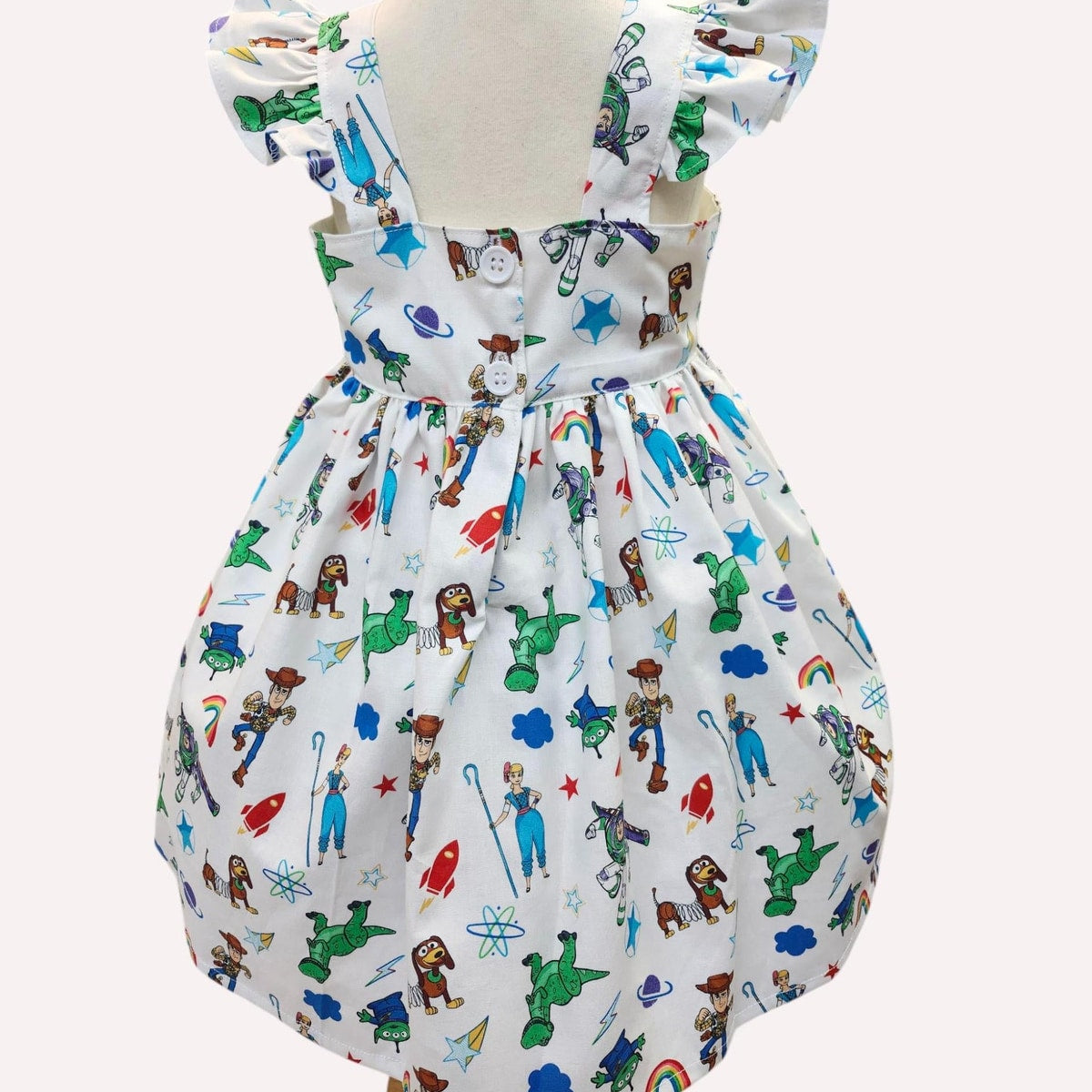 Children's dress with colorful character pattern on a white background