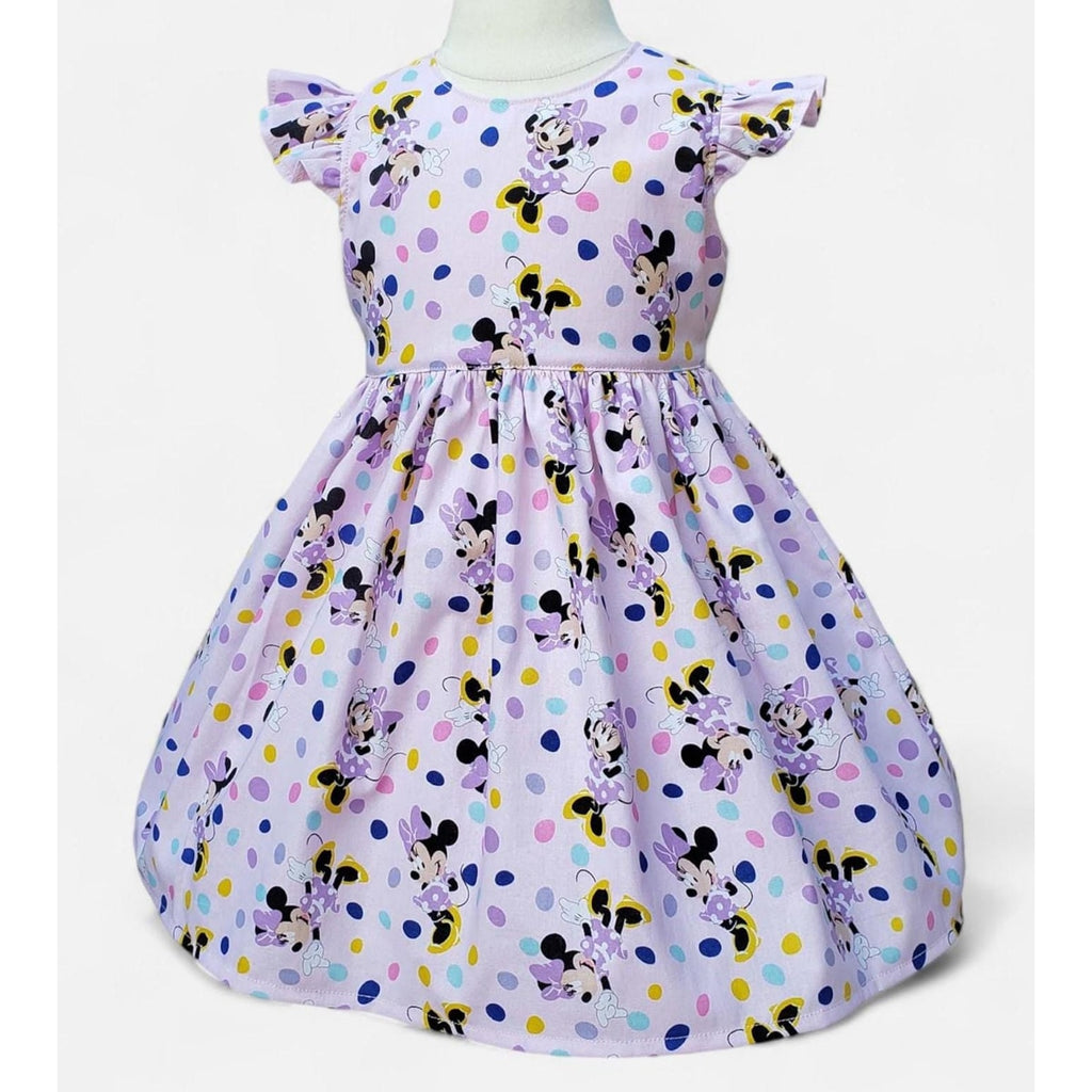 Children's dress with Minnie Mouse pattern on a white background