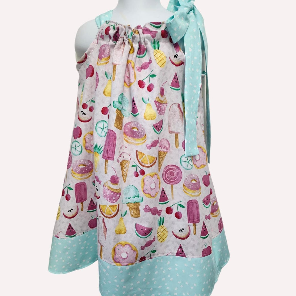 Colorful apron with fruit and dessert pattern on a white background