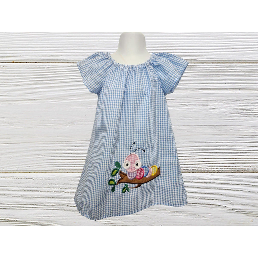 Blue checkered dress with embroidered design on a white background