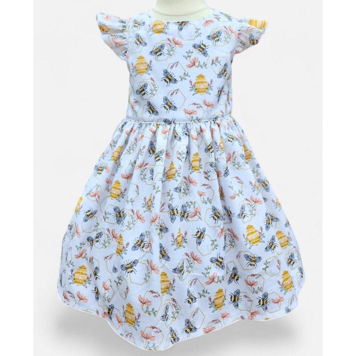 Children's dress with bee and flower pattern on a white background