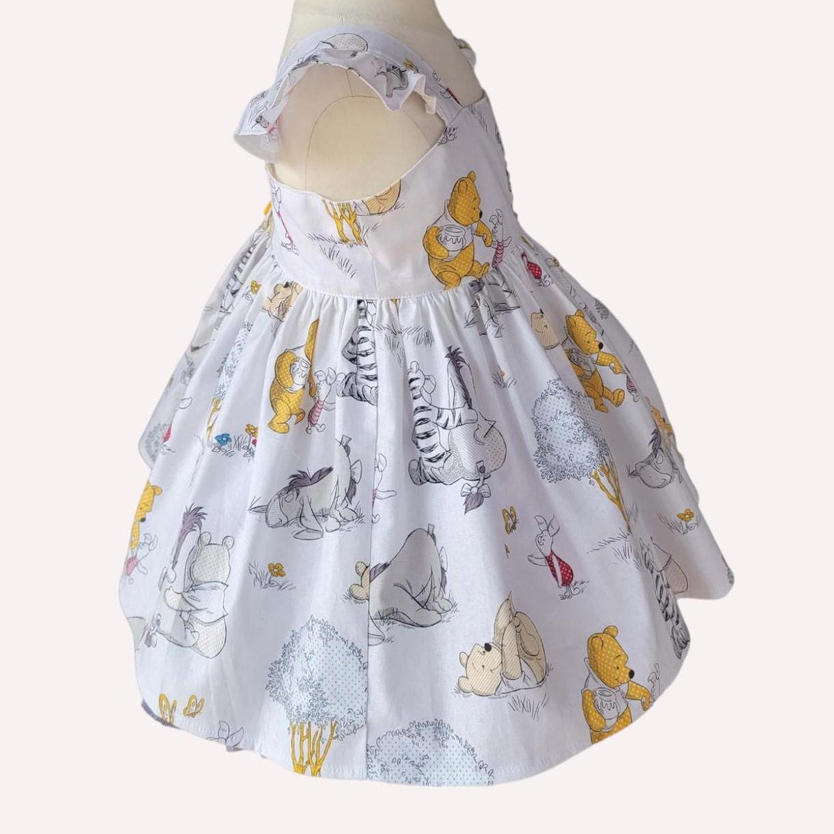 Skirt with cartoon character pattern on a mannequin against a white background