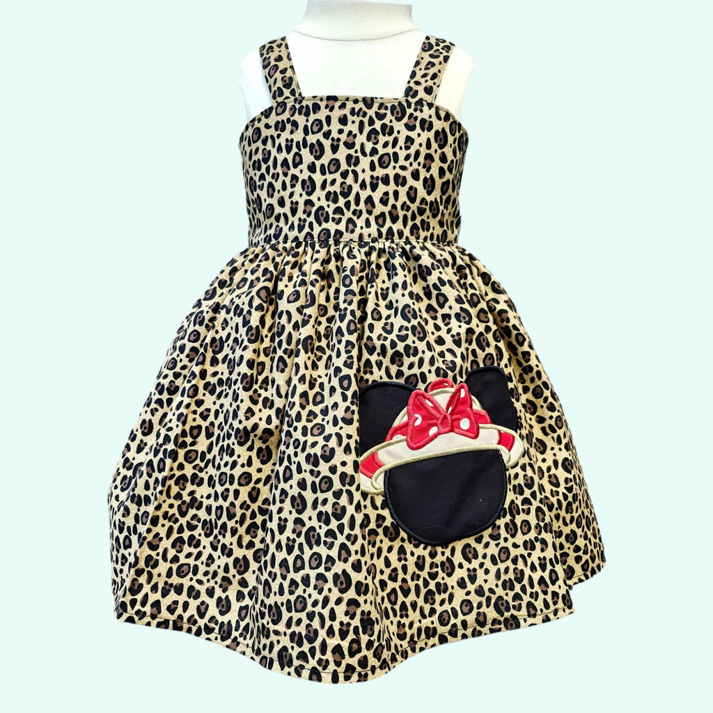 Leopard print dress with a character design on a light blue background