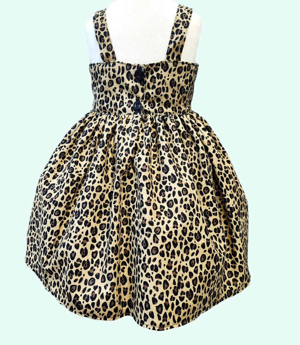 Leopard print dress on a mannequin against a light blue background