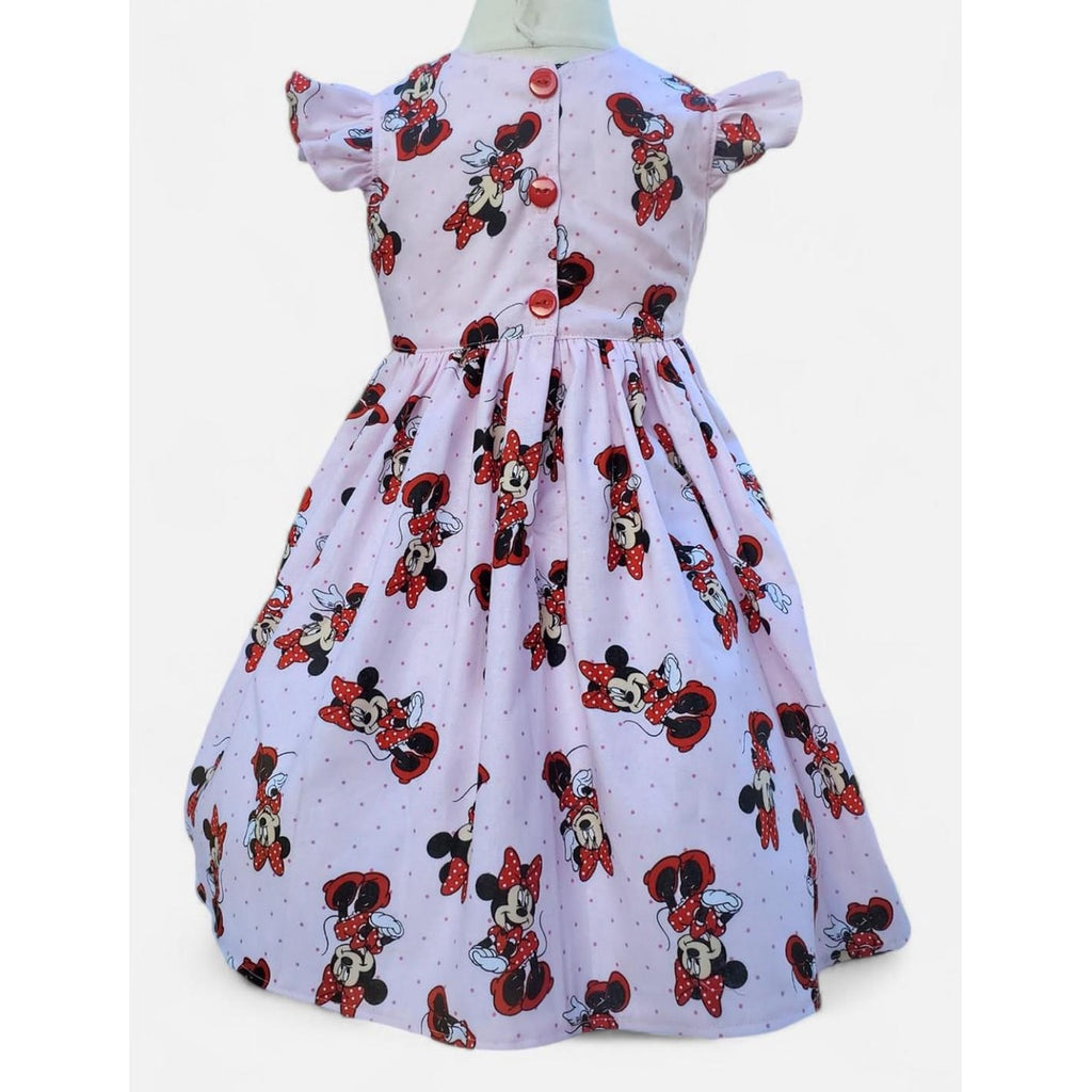 Children's dress with Minnie Mouse print on a white background
