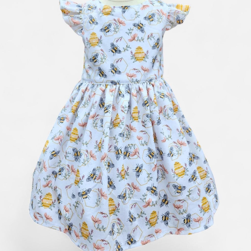 Dress with bee and flower pattern on a white background