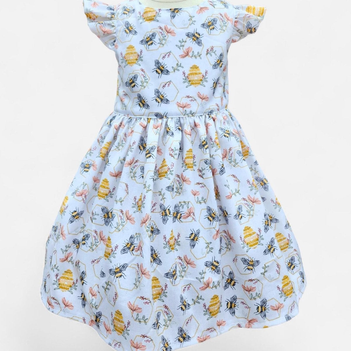 Dress with bee and flower pattern on a white background
