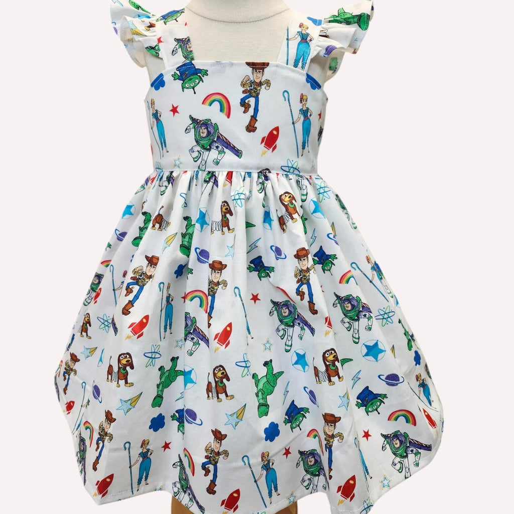Children's dress with colorful cartoon character print on a white background