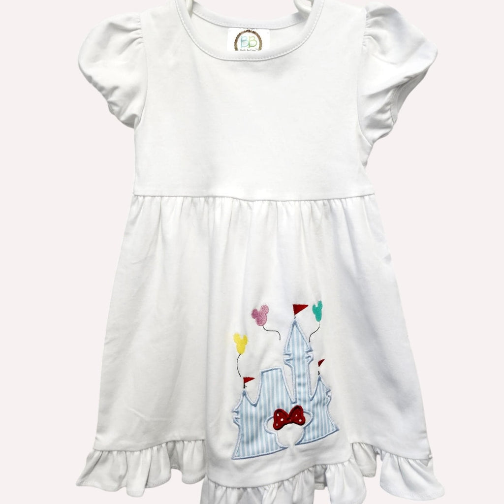 White dress with colorful appliqués on a white background