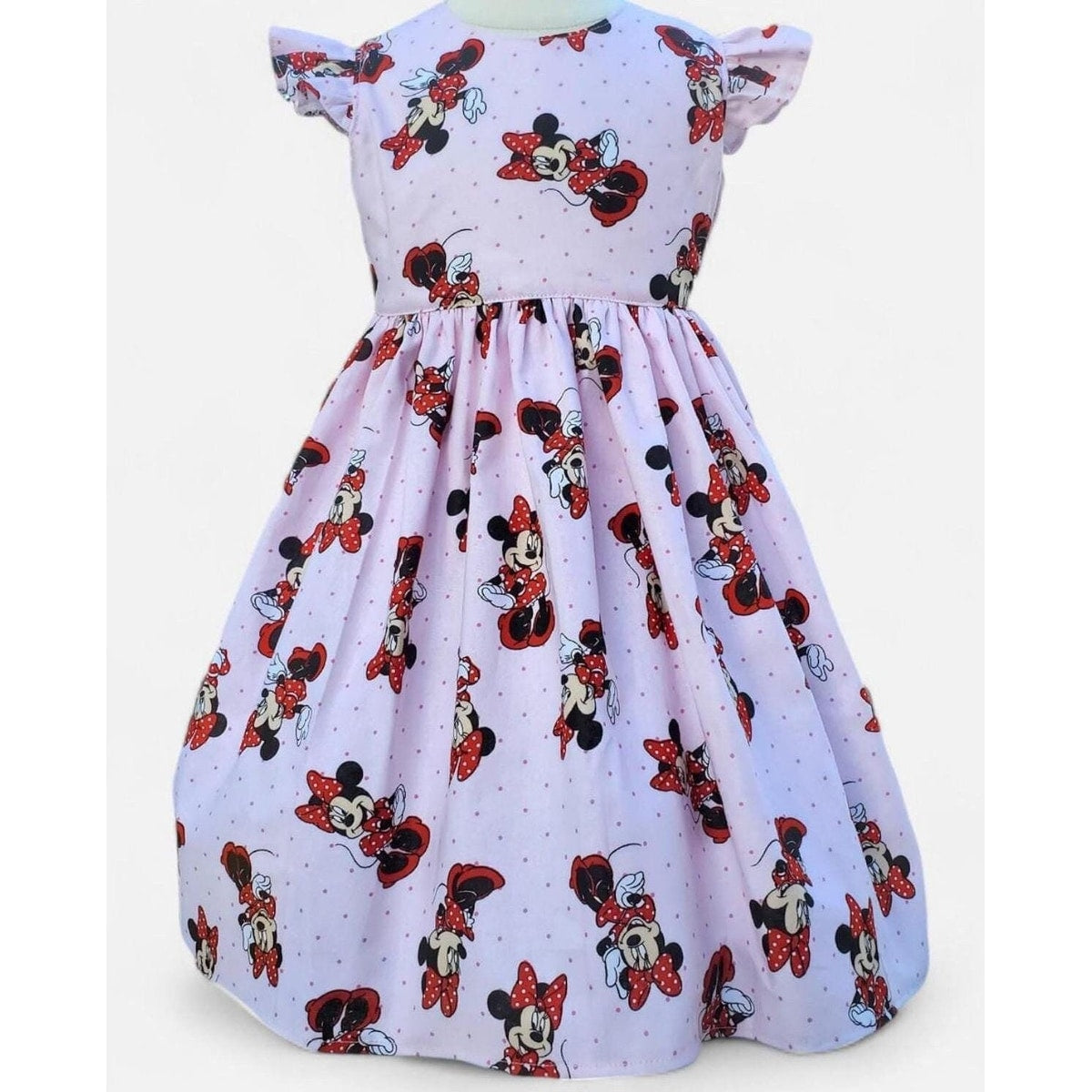 Children's dress with Minnie Mouse print on a white background