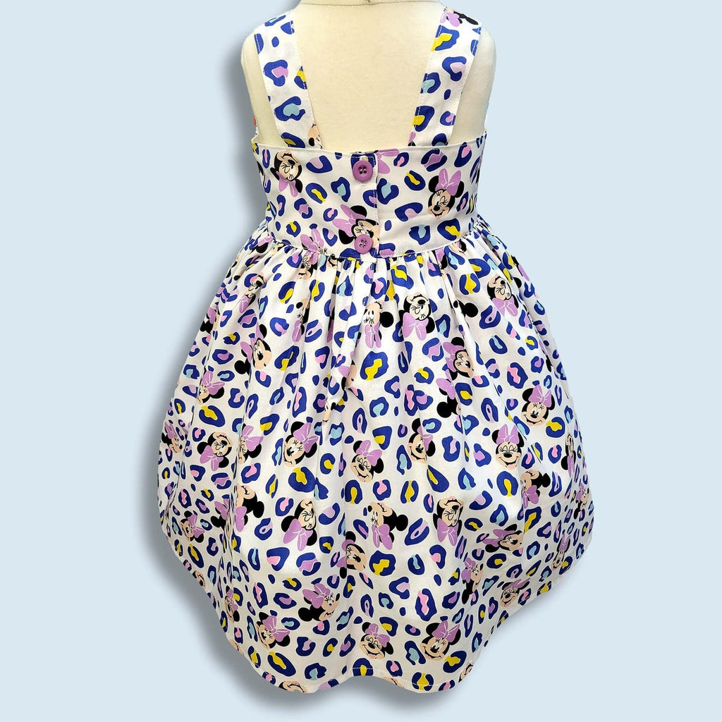 Dress with Minnie Mouse pattern on a light blue background