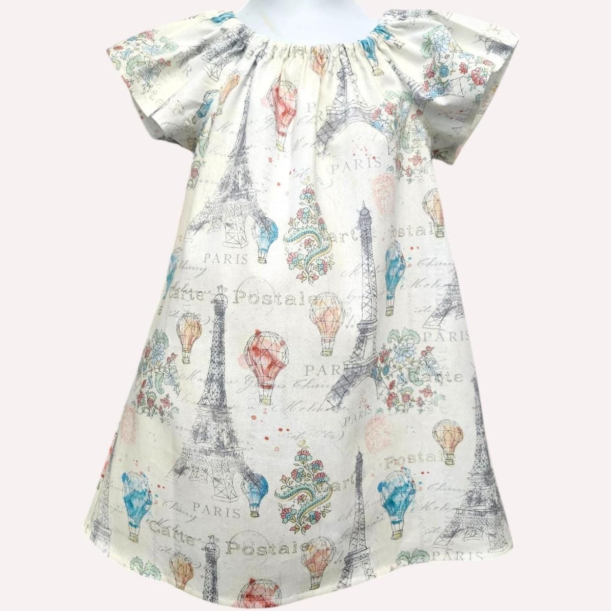 Dress with Paris-themed print featuring Eiffel Tower and hot air balloons on a white background