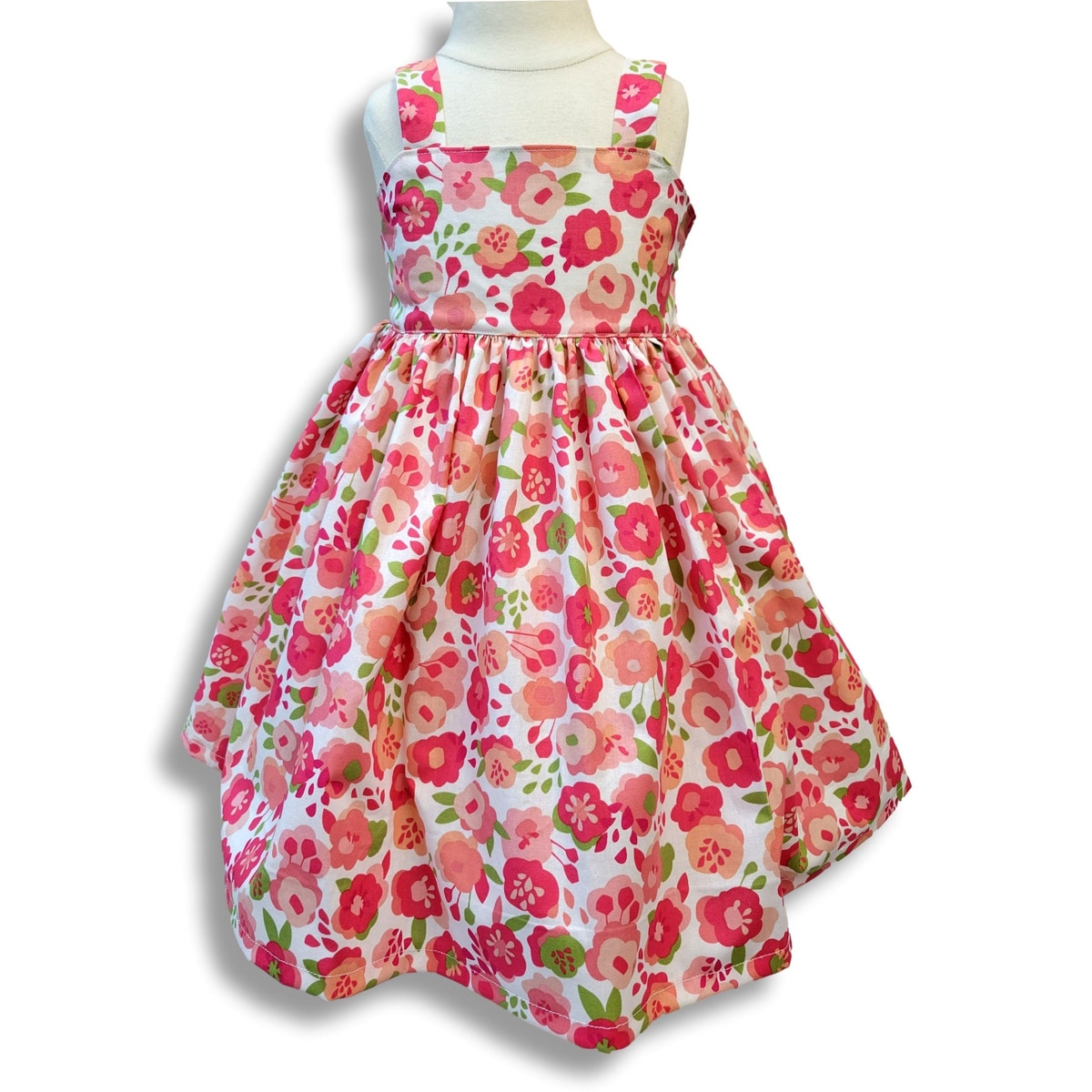 Floral dress on a mannequin against a white background