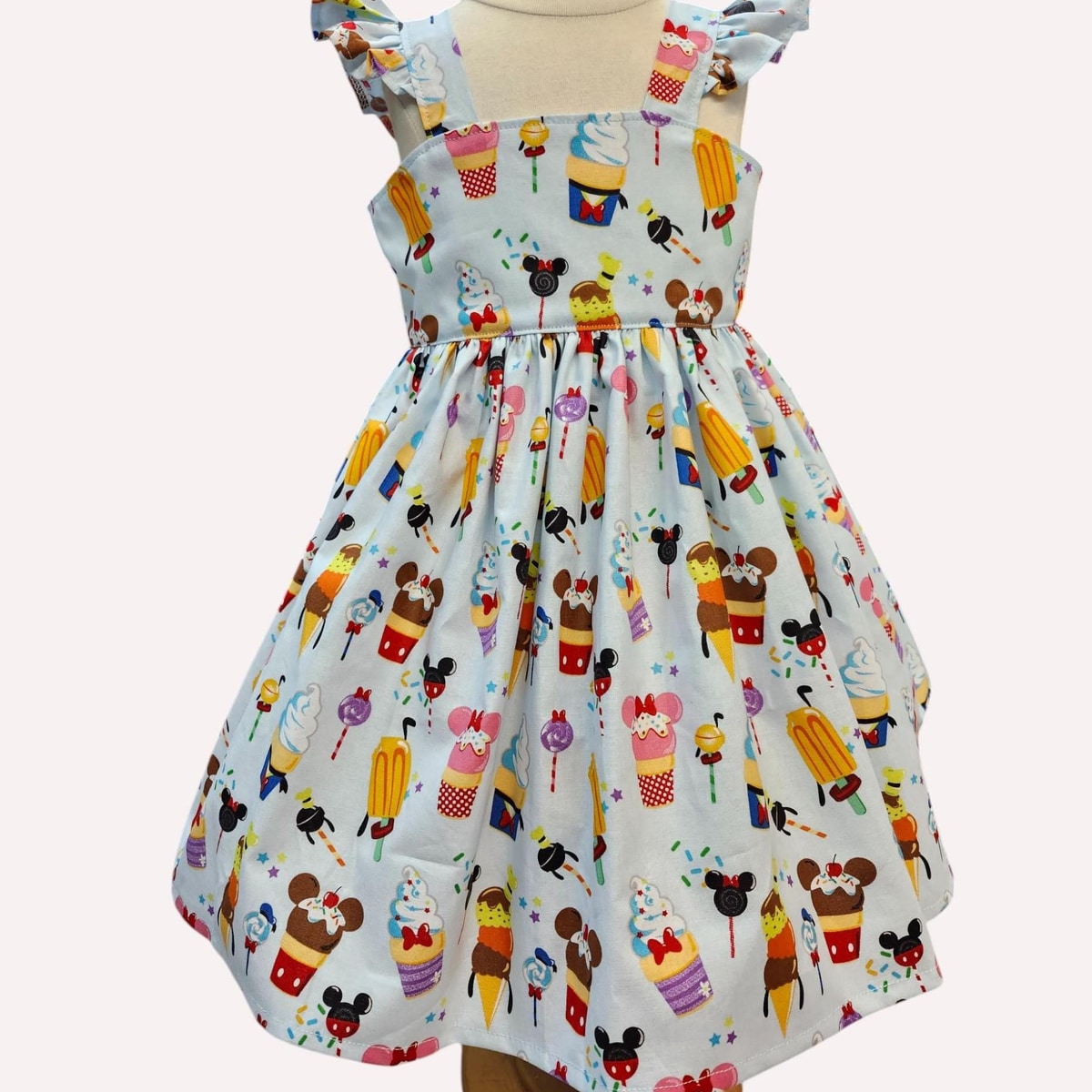 Children's dress with colorful ice cream and character pattern on a white background