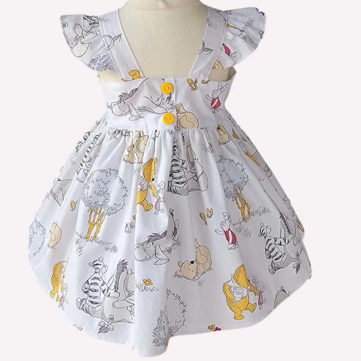 Children's dress with cartoon character print on a white background