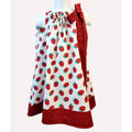 Dress with strawberry pattern on a mannequin against a white background