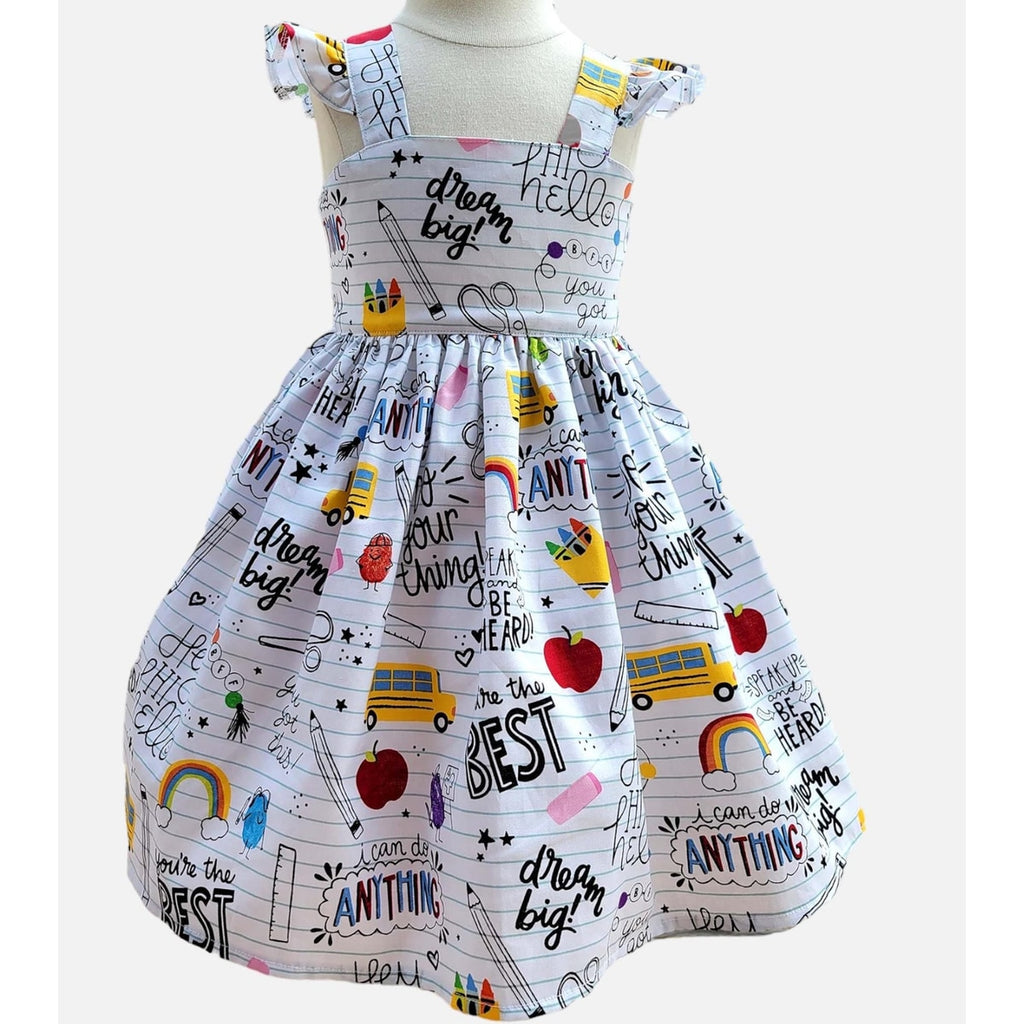 Children's dress with motivational text and colorful graphics on a white background