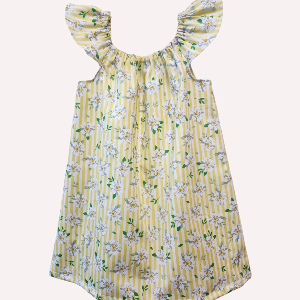 Yellow floral dress with ruffled straps on a white background