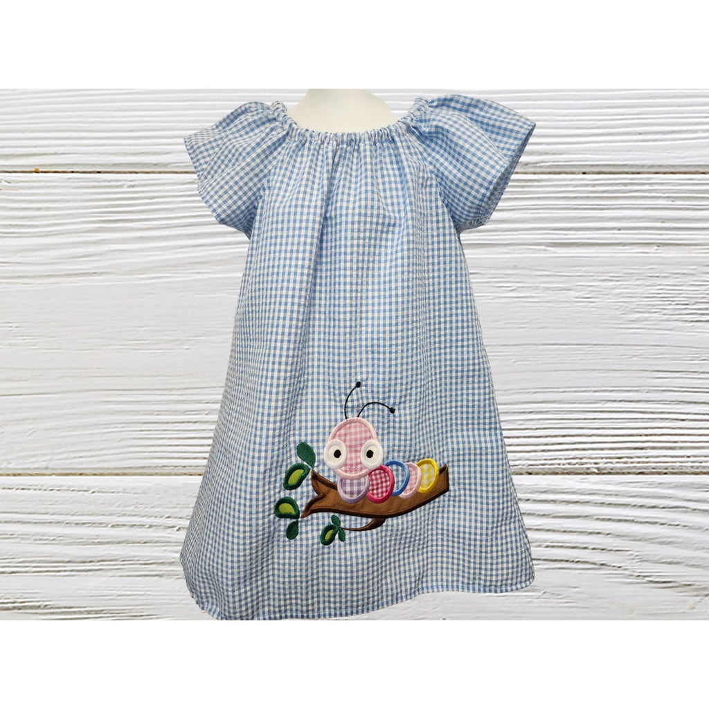 Blue checkered dress with embroidered owl design on a white background