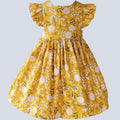 Yellow floral dress on a light gray background