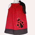 Red polka dot dress with a ladybug design on a mannequin against a white background