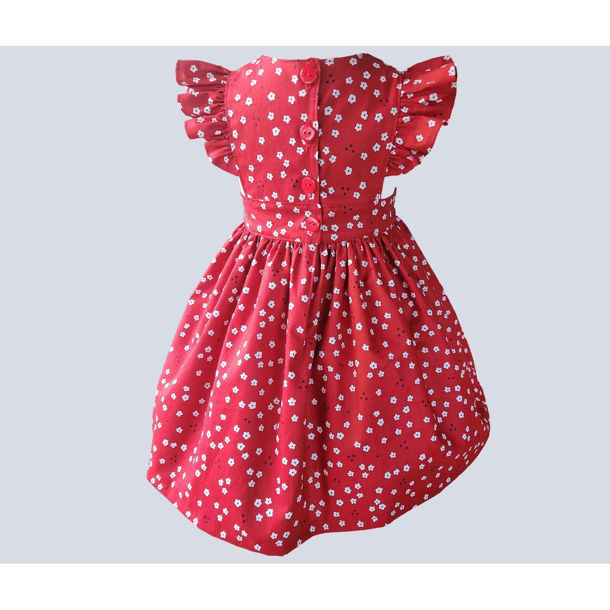Red dress with white floral pattern on a light gray background