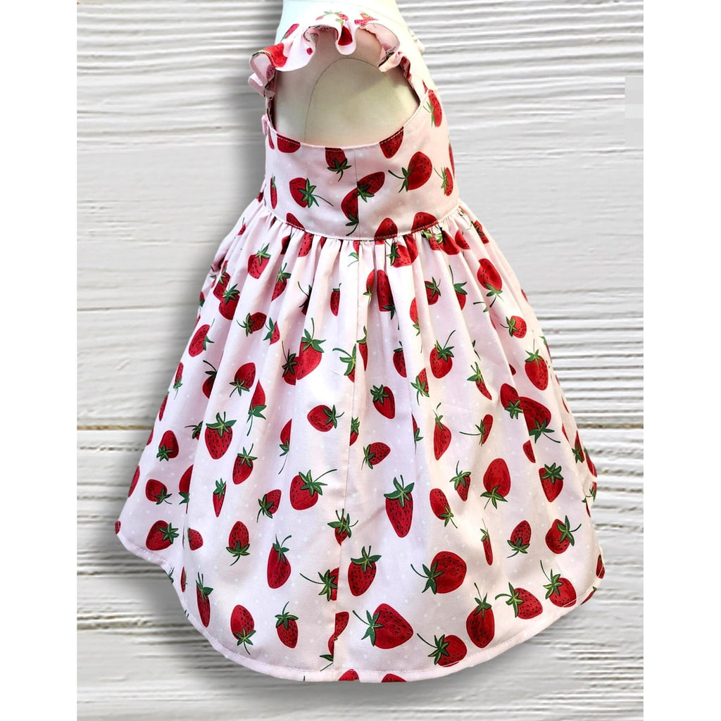 Children's dress with strawberry pattern on a white background