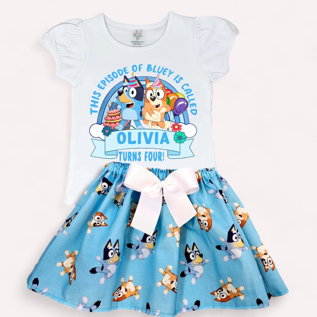 Children's dress with Bluey character design and personalized text on a white background