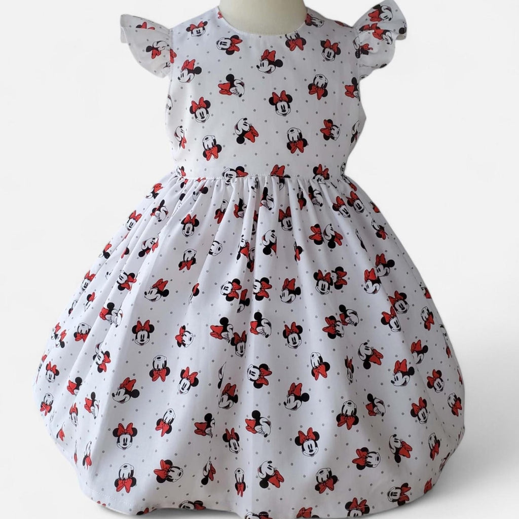 White dress with Minnie Mouse pattern on a white background