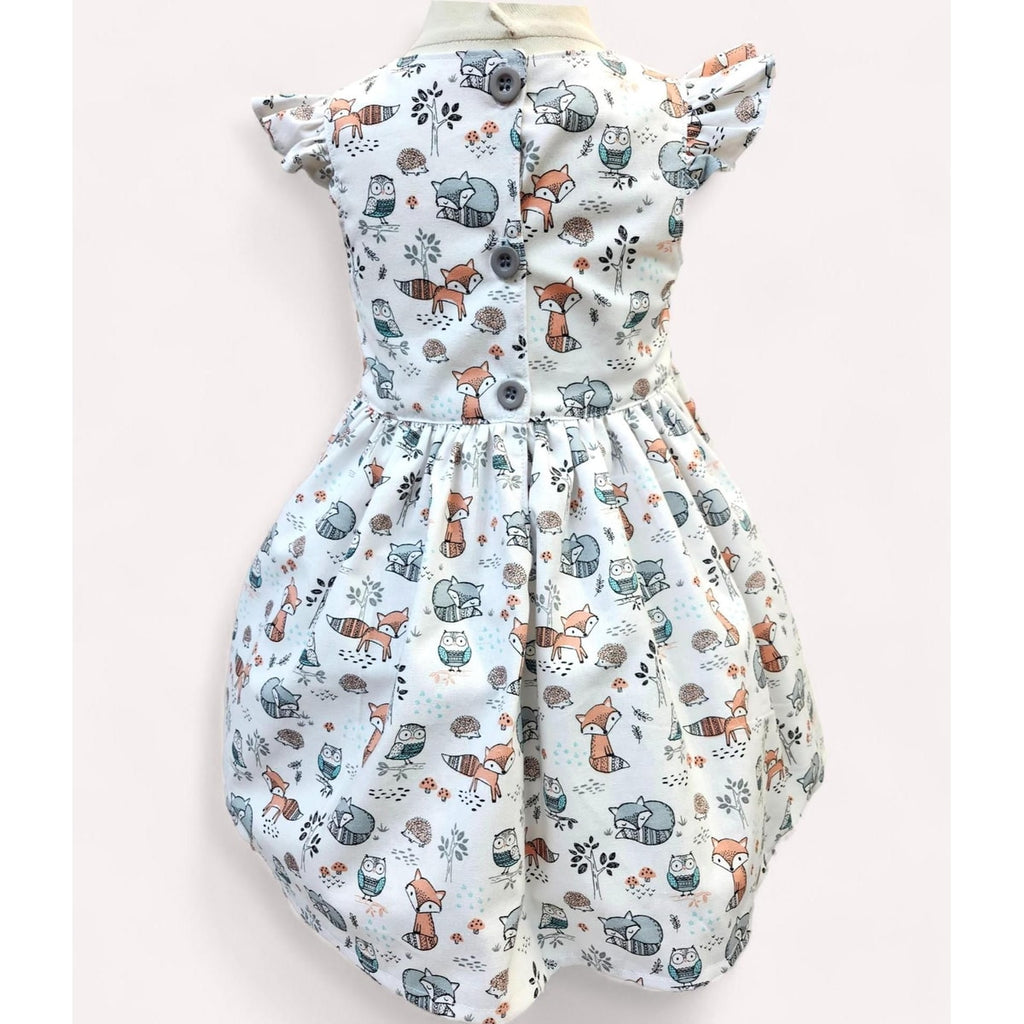 Baby romper with animal pattern on a light pink background
