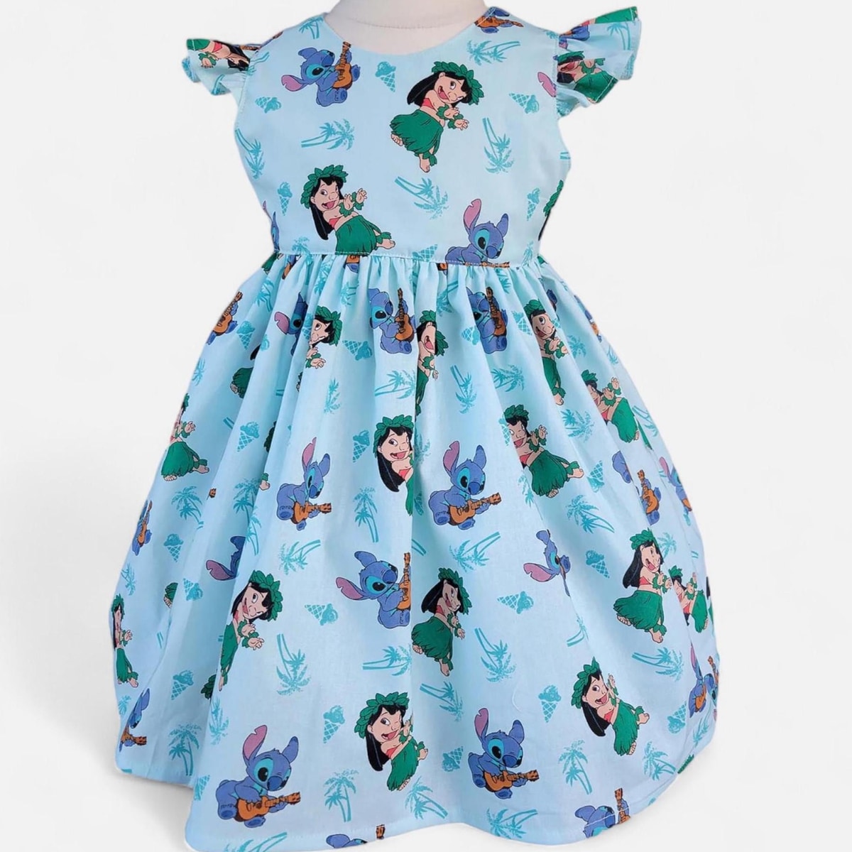 Children's dress with cartoon character print on a light blue background