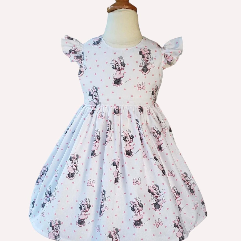 Children's dress with Minnie Mouse print on a mannequin against a white background