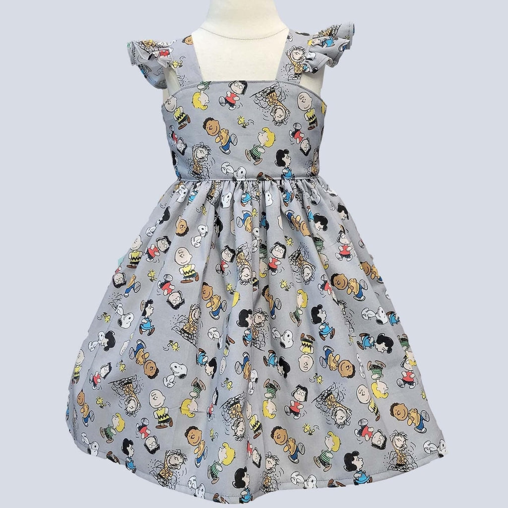 Children's dress with cartoon character pattern on a light gray background