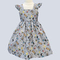 Children's dress with cartoon character pattern on a light gray background