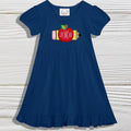 Navy blue dress with a colorful pencil and apple design on a wooden surface