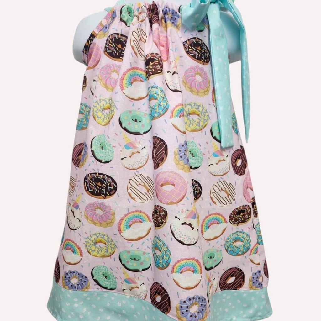 Baby dress with donut pattern on a white background