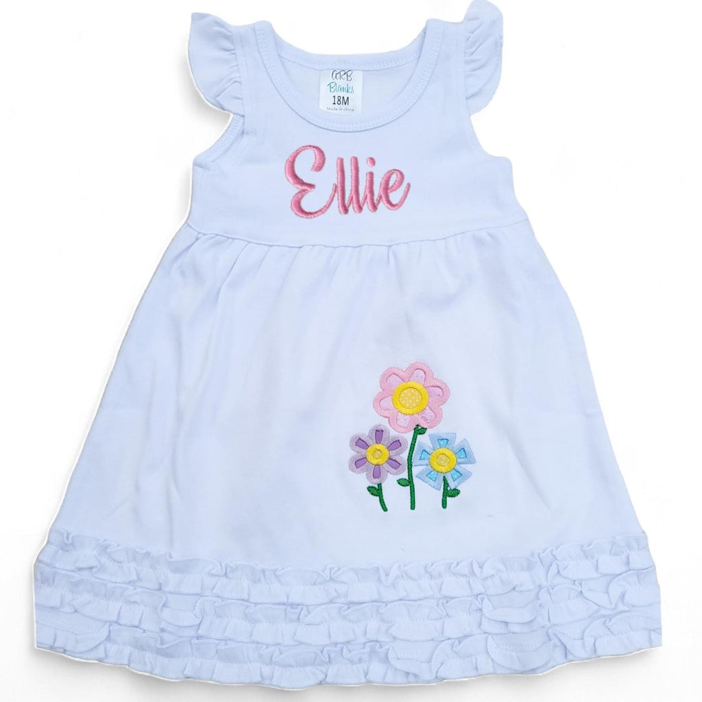 Light blue dress with embroidered flowers and name 'Ellie' on a white background