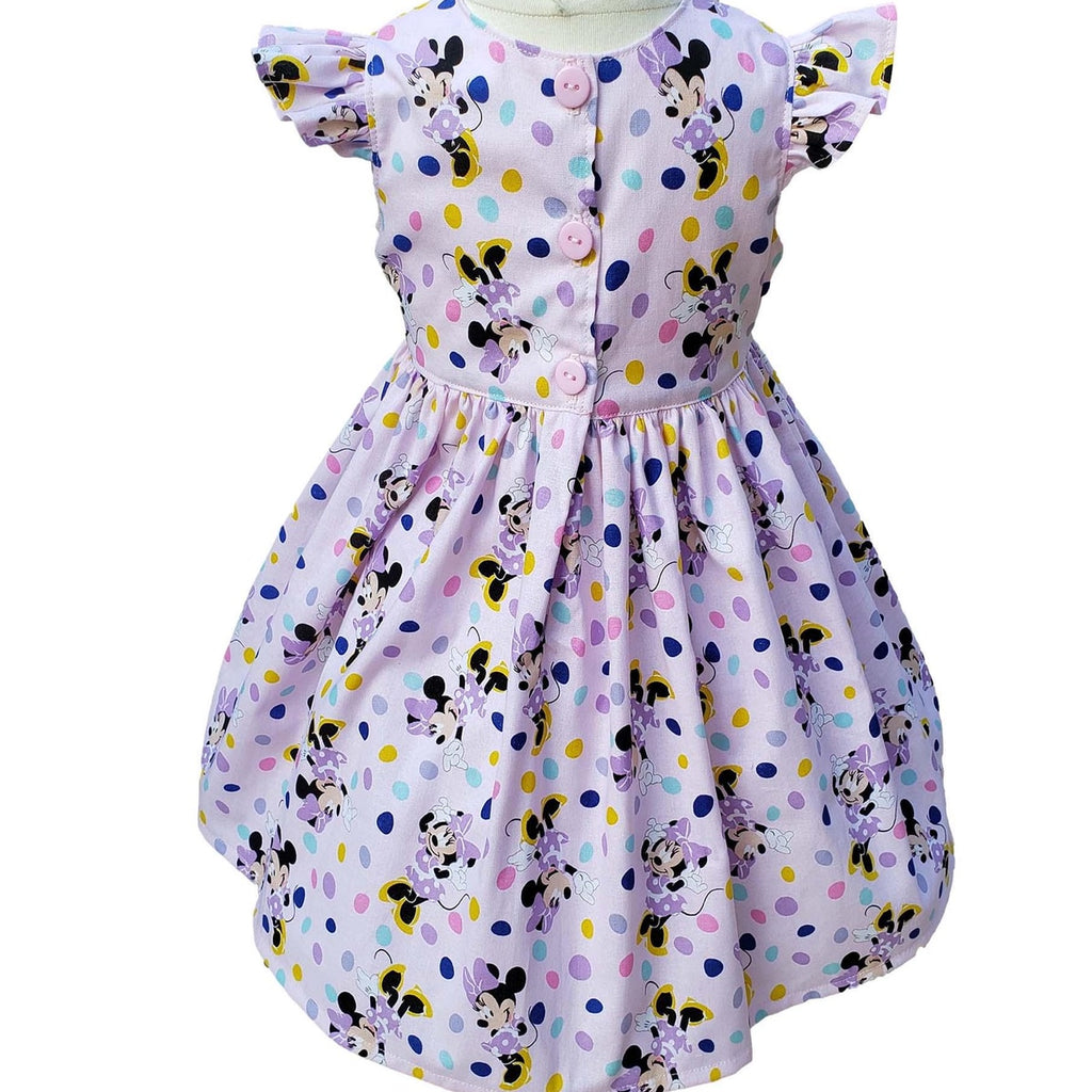 Children's dress with Minnie Mouse pattern on a white background