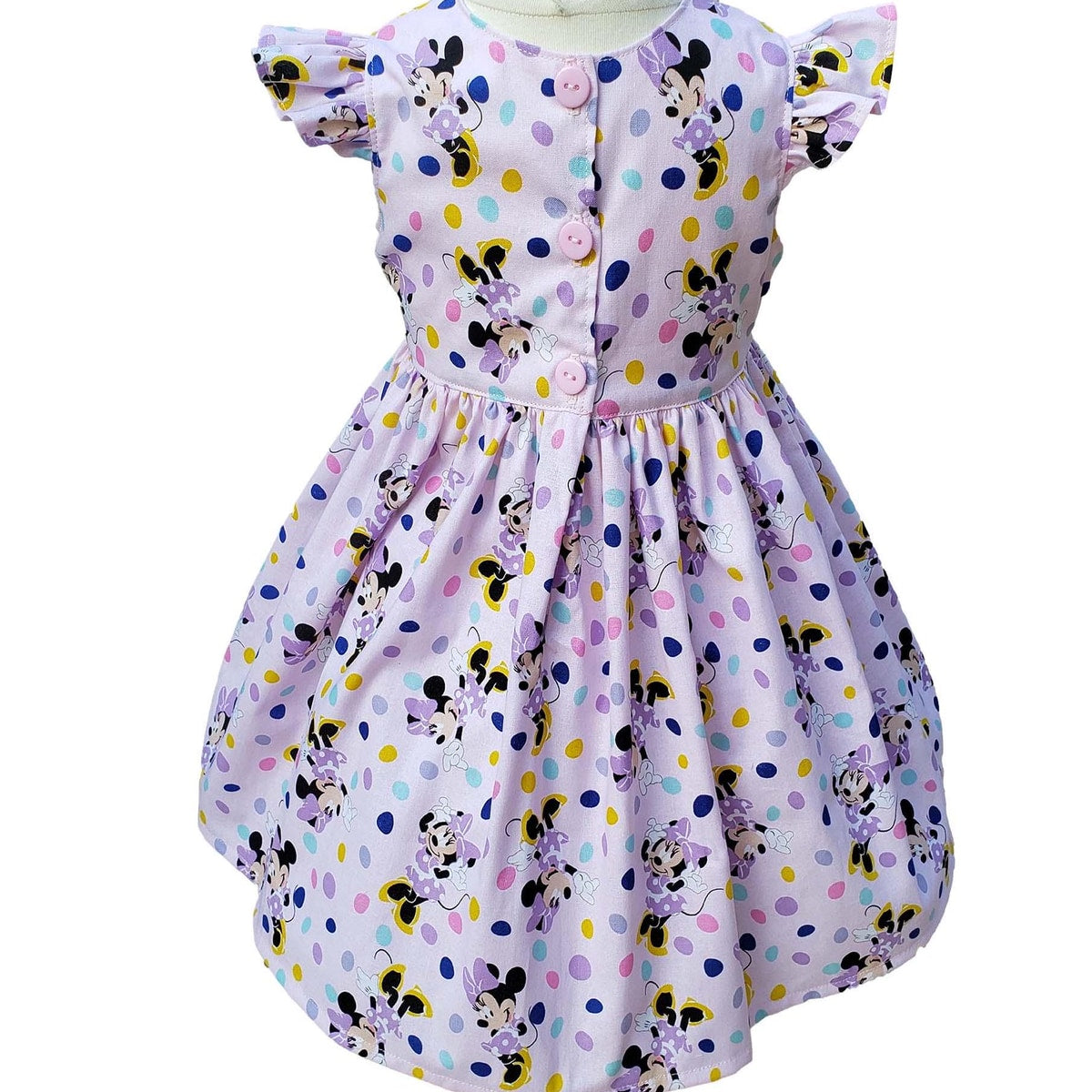 Children's dress with Minnie Mouse pattern on a white background