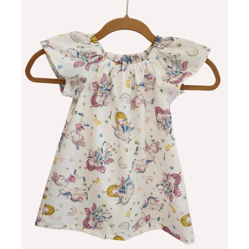 Children's dress with mermaid pattern on a hanger against a white background