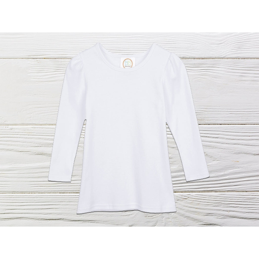 White long-sleeve shirt on a light wooden surface